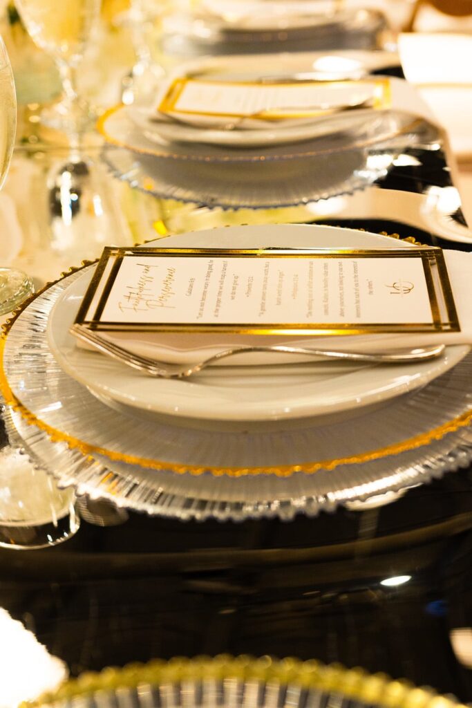 Layered charger and custom printed menu card showing personalized event touches