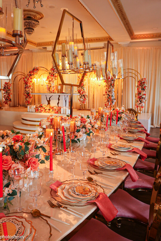Coral and deep gold wedding table design with saturated floral palette