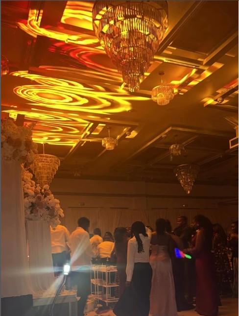 Textured gold ceiling lighting projection creating a dynamic ambience at a wedding reception